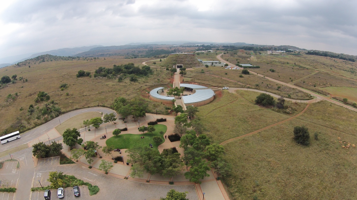 An aerial view of the Cradle of Humankind, showcasing the expansive landscape and the unique architecture of the visitor center.